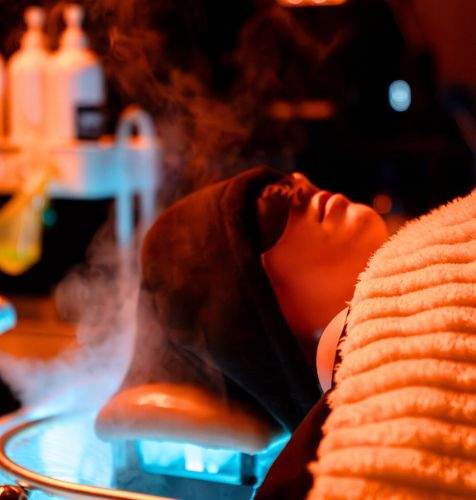 a woman getting a relaxing head spa treatment at the modern halo in Houston